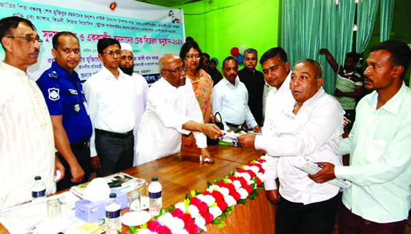 NETRAKONA: State Minister for Social Welfare Ashraf Ali Khan Khasru MP distributing cheques among the patients of different diseases and allowances for old aged and widows at local Public Hall premises on the occasion of the birth centenary of Bangaban