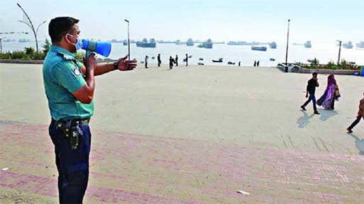 A policeman seen announcing the ban on gathering at Patenga Sea Beach on Wednesday. Photo: Collected