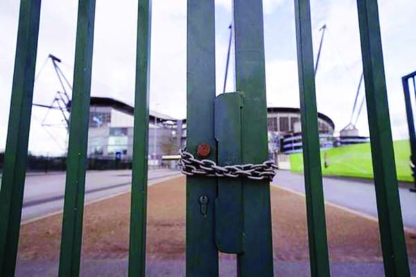 A locked gate is seen by Premier League champion Manchester City's home ground on Friday.