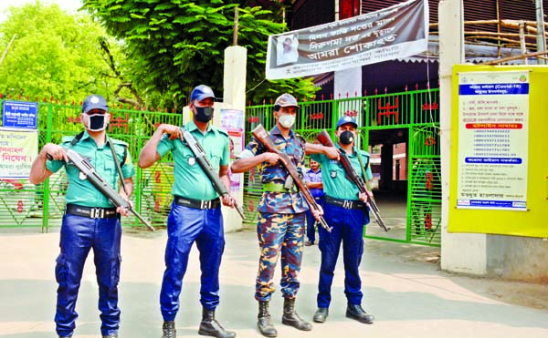 Law-enforcers stand guard in front of Dhakeshwari National Temple on Monday to resist mass gathering in the temple due to outbreak of coronavirus.