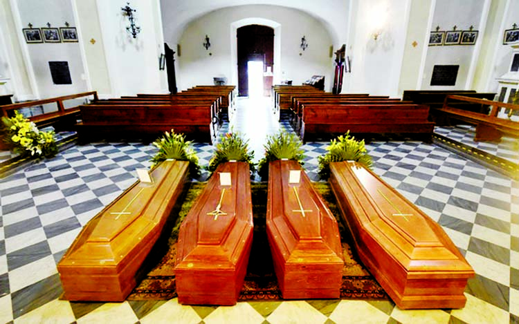 Coffins are seen inside a church in Serina near Bergamo city, worst-hit by coronavirus disease in Italy.