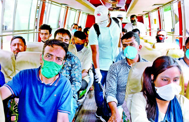 A volunteer sprays disinfecting in a public bus at Shahbagh intersection in Dhaka on Monday as a preventive measure against possible spread of novel coronavirus.