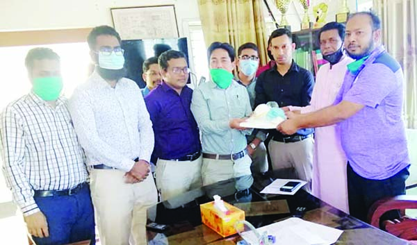BETAGI(Barguna): Dr Abdullah, Upazila Lifestoke Officer and Md Ahsan Habib, UNO handing over 12 sets of Personal Protective Equipments(PPE) to Dr Tang Mong, Upazila Health and Family Planning Officer for doctors of Betagi Upazila Health Complex on Tues