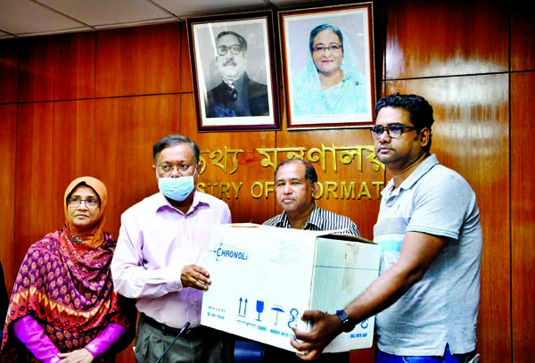 Information Minister Dr Hasan Mahmud presenting coronavirus preventing kits among the journalists at the seminar room of the Ministry on Wednesday.