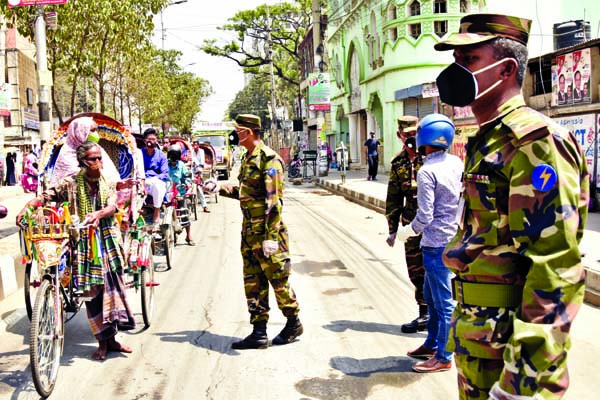 Army personnel calling upon the commoners to stay at home to protect themselves from coronavirus. The snap was taken from the city's Azimpur area on Saturday.