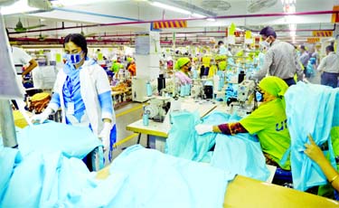 Workers producing personal protective equipment (PPE) for health professionals at a garment factory of Urmi Group in Dhaka on Saturday amid rising demands for PPE due to the coronavirus outbreak here.