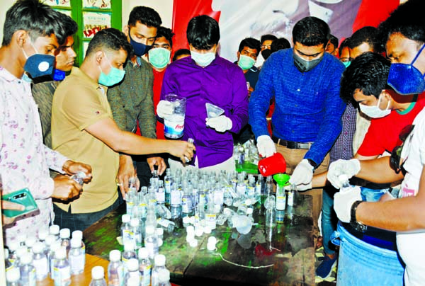 Bangladesh Chhatra League leaders and activists producing hand Sanitiser to distribute among the people free of cost. This photograph was taken from Madhu's Canteen on Sunday.