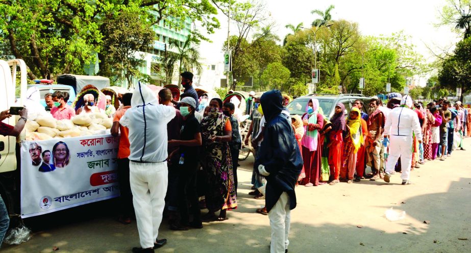 Different government and non-government organisations distributing food among the day-labourers and destitute. The snap was taken from the High Court area on Tuesday.