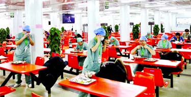 Medical workers eat at separate tables at a canteen inside Xiaotangshan Hospital, a hospital built in 2003 to treat patients with Severe Acute Respiratory Syndrome (SARS) that is now used to treat patients with coronavirus disease in Beijing.