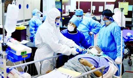 Emergency medical staff and nurses wearing protective suits, help while transferring a patient with coronavirus disease to Masih Daneshvari Hospital in Tehran.