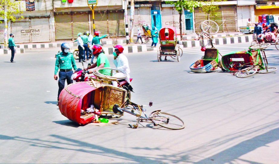 Police prevent rickshaws to ply on city roads on Wednesday as people started moving out of their homes defying the government's stay home order amid coronavirus outbreak.