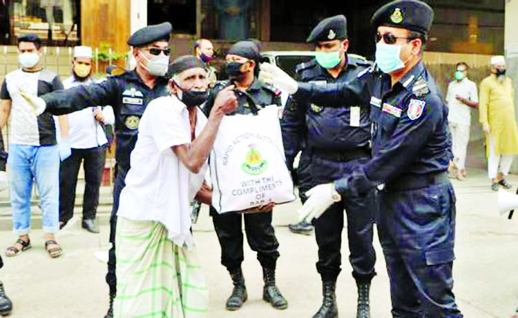 RAB-4 distributing food among the poor people at its office in the city's Mirpur on Thursday