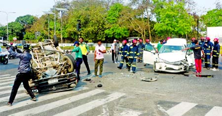A car turns turtle after hitting another one on the road in front of the Prime Minister's Office on Thursday as streets in Dhaka remains deserted encouraging motorists for reckless driving.