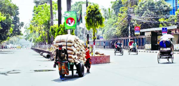 Day-labourers engaged in carrying goods by a pushcart taking risk of coronavirus. The snap was taken from in front of RAJUK Bhaban in the city on Saturday.