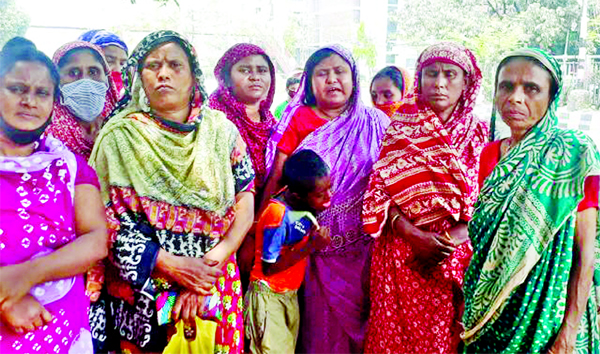 Distressed women are waiting for the relief goods defying the order of social distance in city's Green Road area on Sunday.