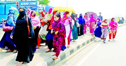 Garment workers walk to join their duty defying social distanceing. This snap was taken from city's Tejgaon Industrial Area on Sunday.