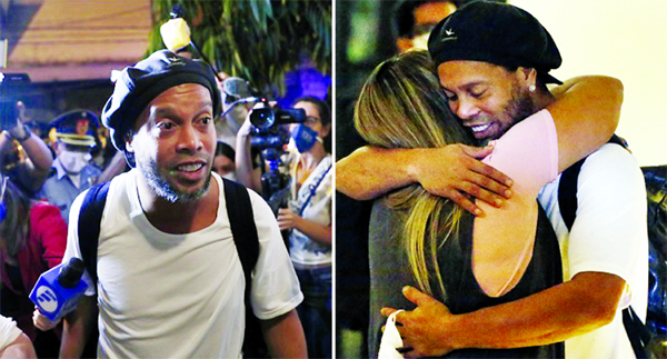 Former Brazilian soccer star Ronaldinho is embraced by a woman as he arrives at a hotel where he is to stay under house arrest in Asuncion, Paraguay onTuesday. Ronaldinho and his brother Roberto De Assis Moreira spent a month in jail accused of entering P