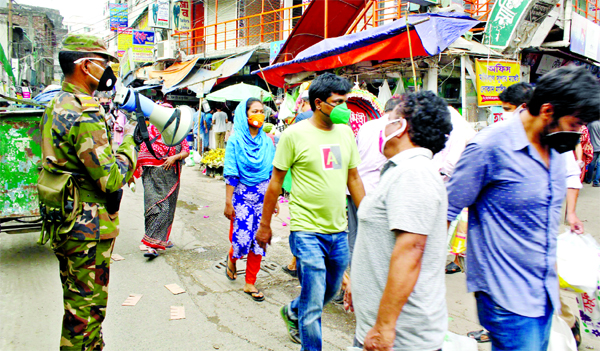 Different agencies including Bangladesh Army raising awareness to the common people through mike to stay home in preventing coronavirus. The snap was taken from the city's Malibag area on Wednesday.