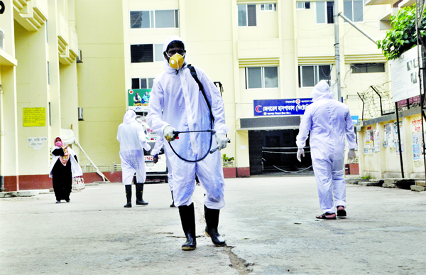 Employees of Narayanganj Victoria General Hospital spraying germicide around the hospital on Wednesday as the entire Narayangonj district was put under the total lockdown over coronavirus fear.