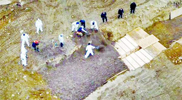 Workers digging mass graves in Hart Island, New York City, as the death toll from the coronavirus outbreak continues to rise in the USA.