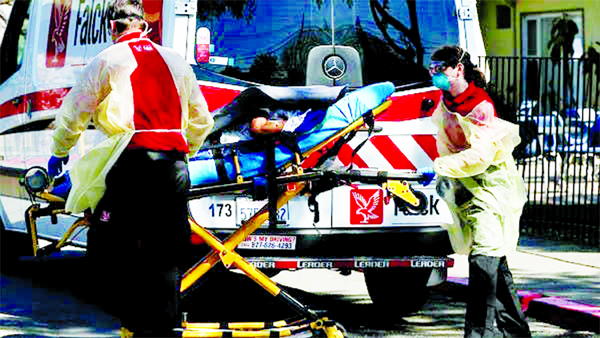 An ambulance crew transports a patient to Gateway Care and Rehabilitation Center, where 7 deaths and 65 confirmed cases of coronavirus among its staff and patients were reported in Hayward.