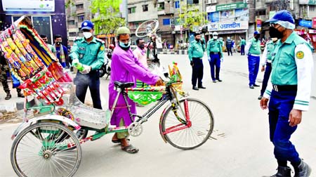 Police personnel spraying germicide on the seat of a rickshaw to make it coronavirus free. This picture was taken from city's Culvert Road area in Dholaikhal on Sunday.