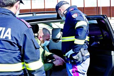 Italian Police officers control motorists at the A4 highway in Bergamo to ensure that they comply with the 'stay-at-home' orders in a bid to slow down the spread of the coronavirus disease on Sunday.