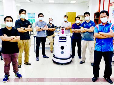 Engineering professors pose with the version two prototype of the IIUM Medibot medical robot at the International Islamic University Malaysia in Gombak, on the outskirts of Kuala Lumpur on Monday.