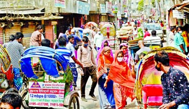 People swarm a road at Khilgaon Nandipara in Dhaka on Monday forgetting social distancing protocol during the nationwide lockdown to limit the spreading of coronavirus disease.