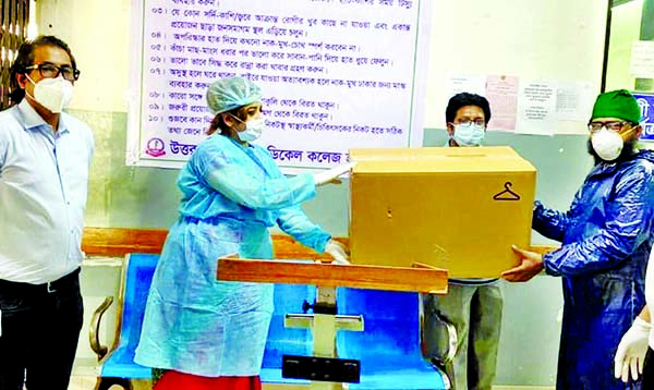BNP Organising Secretary Shama Obaed Islam handing over PPE for physicians to the authority of the city's Uttara Modern Medical College Hospital on Wednesday.