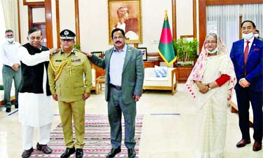 Home Minister Asaduzzaman Khan Kamal adorning with the IGP rank badge to newly appointed IGP Benazir Ahmed at Ganabhaban on Wednesday. Among others, Prime Minister Sheikh Hasina was present on the occasion. BSS photo