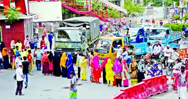 Garment workers take to the Mirpur-10 road in Dhaka on Wednesday demanding payment of arrear wages.
