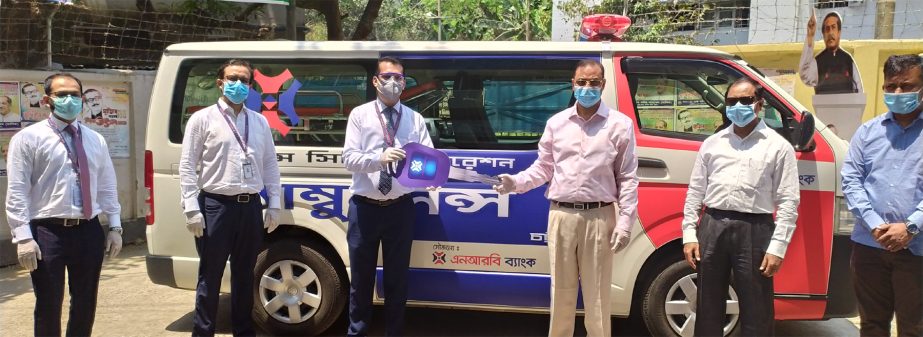 A J M Nasir Uddin Ahmed, Mayor of Chattogram City Corporation (CCC), receiving key of an Ambulance from Sarker Mehadhi Reza, Head of O R Nizam Road Branch of NRB Bank Limited, at the CCC on Monday. Md Samsudoha, Chief Executive Officer of Chattogram City
