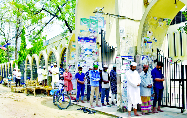Some devotees offering Jum'a Prayers outside the mosque being failed to enter the mosque as more than ten devotees were not allowed to say Jum'a prayers due to coronavirus. The snap was taken from in front of Baitul Mokarram National Mosque in the city