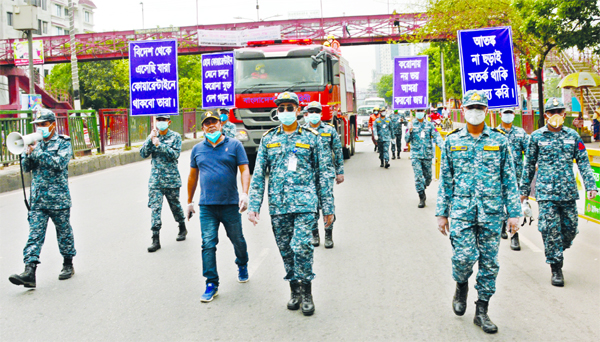 Members of Bangladesh Navy brought out a rally with slogans written on placard with a view to raising awareness among the people to resist coronavirus. The snap was taken from in front of American Embassy in the city's Gulshan on Saturday.