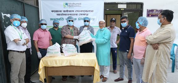 Md ShafiulAzam, Managing Director & CEO of Modhumoti Bank Limited, handing over food items to 15,000 helpless families in 75 Wards (200 families of each Ward) under Dhaka South City Corporation on Sunday. Bank's DMDs Kazi Ahsan Khalil and Shahnawaj Chowd
