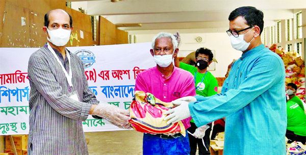 State Minister for Shipping Khalid Mahmud Chowdhury handed over relief goods to DNCC Mayor Atiqul Islam on behalf of Shippers Council of Bangladesh (SCB) at Banani Bidyaniketon on Sunday. SCB Chairman Rezaul Karim was present on the occasion among others.