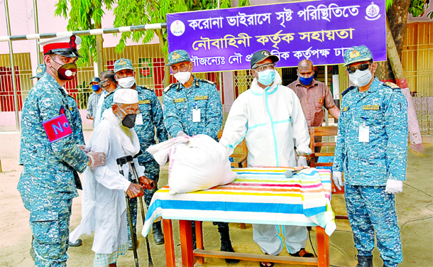 Members of Bangladesh Navy distributing essentials including rice, oil and potatoes among the poor in the city's Kurmitola High School field on Monday.