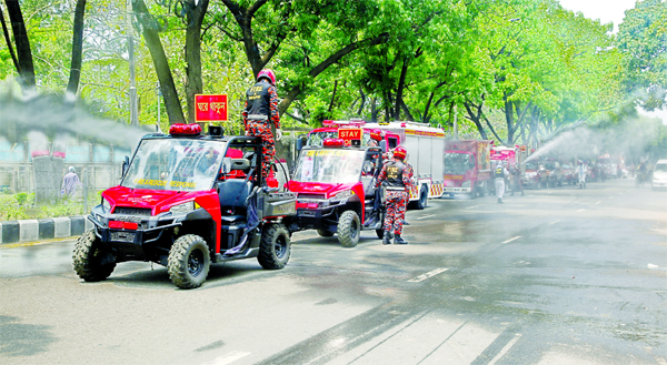 Fire Service and Civil Defence, Dhaka Division led by its Deputy Director Debashih Bardhan spraying water mixed with germicide in different parts of DSCC on Monday to combat coronavirus.