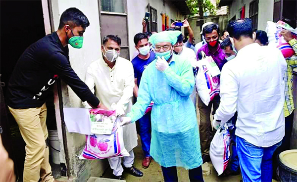 Senior Joint Secretary General of BNP Ruhul Kabir Rizvi distributing relief materials among the destitute in the city's Kafrul thana area on Tuesday.
