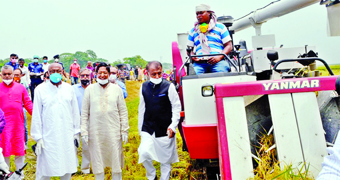 Agriculture Minister Dr Abdur Razzak, among others, at the inaugural ceremony of paddy harvesting machine at Madon Upazila in Netrakona on Tuesday.