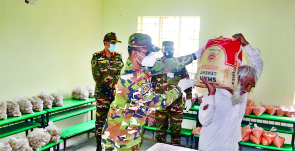 Bangladesh Army distributing relief materials among the distressed people in Munshiganj to ensure home quarantine and to prevent spread of Coronavirus on Sunday.