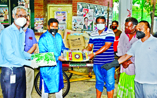 On behalf of Icon Foundation, Hazi Md Awal Hossain, Councillor of Ward No-33 handing over hand gloves, masks and other equipment to family of cleaners at Majed Sardar Community Center on Sunday.