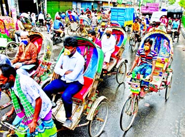 A large number of rickshaws ply on the city roads on Sunday amid reopening of 18 government ministries and apparel factories partially relaxing the nationwide closures. This photo was taken from the city's Bangshal area.