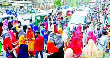RMG workers block road at the Malibagh Chowdhurypara in the city on Sunday demanding their arrear wages.