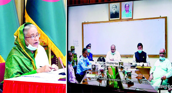 Prime Minister Sheikh Hasina exchanging views with the representatives and officials of seven districts of Rajshahi division on coronavirus situation through video conference from Ganobhaban in the city on Monday..