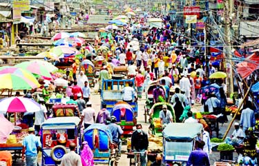 A large number of people swarm on a road adjacent to Shanir Akhra in the city on Monday despite government-imposed nationwide closures to contain the spread of coronavirus.