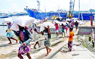 Goods unloading are on at the Majhirghat area of the Chattogram Port on Tuesday amid the countrywide lockdown.