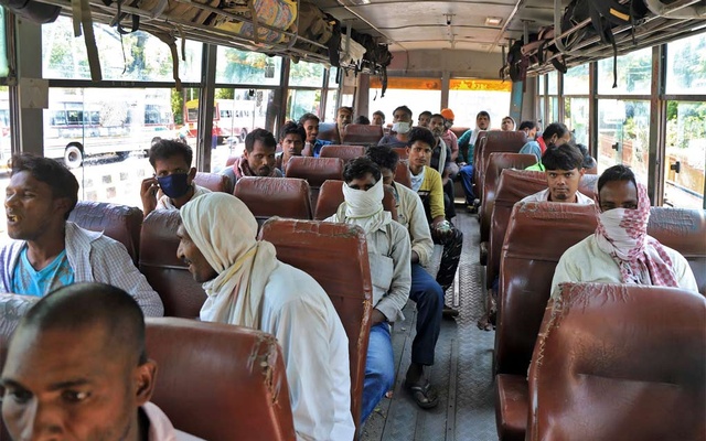 igrant workers, who were stranded in the central state of Madhya Pradesh due to a lockdown imposed by the government to prevent the spread of coronavirus disease (COVID-19), sit in a bus as they wait to leave for their home town, after they arrived in Pra