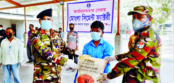 Sena Kalyan Sangstha with the help of the members of Bangladesh Army distributing relief materials among the poor people to tackle coronavirus. The snap was taken from Khulna Mongla Port Area on Saturday.
